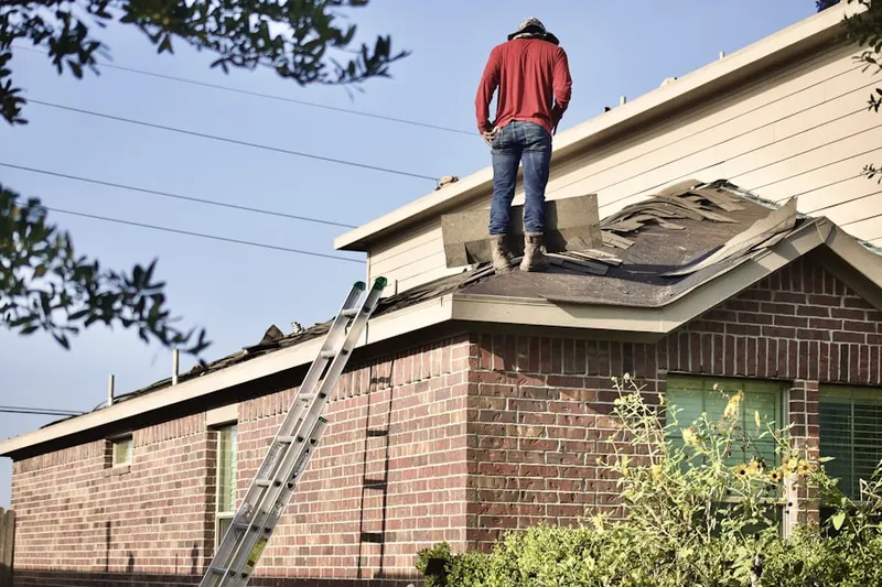 Professional roofer working on a residential roof in Rancho Murieta